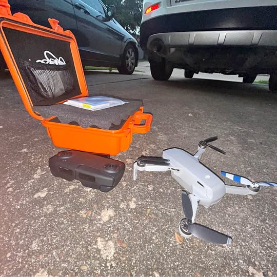DJI Mavic Mini drone with gray controller and orange hard case open