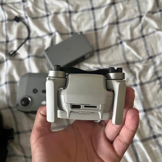 White DJI Mini 2 drone with front arms and landing legs