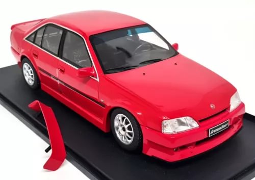 Red diecast model sedan car with front three-quarter view