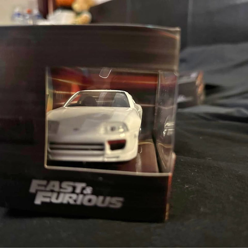 White Toyota Supra diecast toy car front view in clear display box