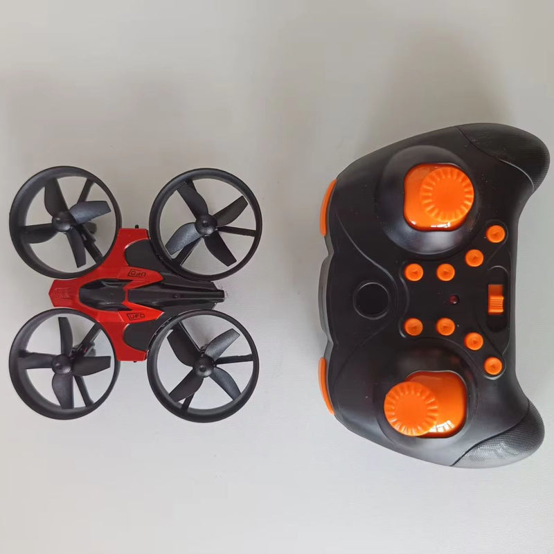 Pocket mini quadcopter drone with four propellers and orange LED lights