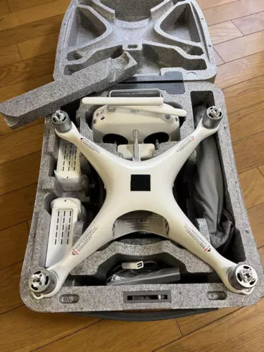 White DJI Phantom 4 Pro quadcopter drone in foam carrying case