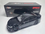 Black diecast model car with detailed front grille and headlights, on display