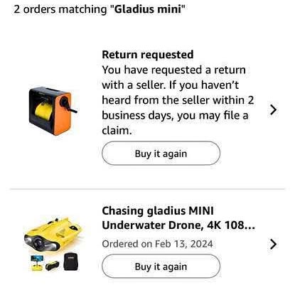 Mini underwater drone with cable reel, orange and black device