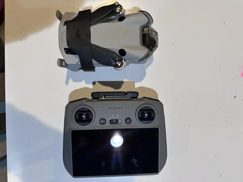 DJI Mini 4 Pro drone and RC 2 controller, gray with dual cameras