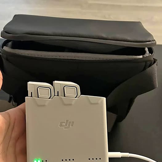 DJI battery pack with charging terminals on black case