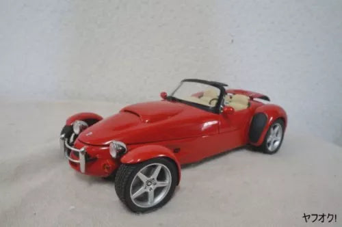 Red diecast roadster car, front three-quarter view with silver wheels