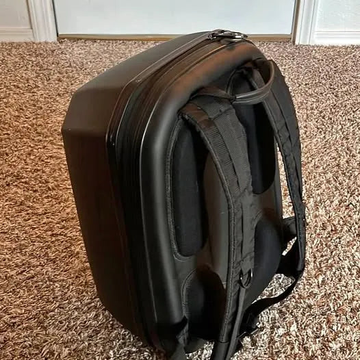 Hard shell drone backpack with padded shoulder straps, dark exterior
