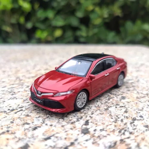 Red diecast model car, front three-quarter view with detailed grille and headlights