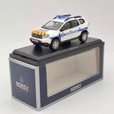 White police diecast car model on black display base, blue-red roof markings