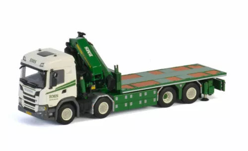 Green and white diecast flatbed truck and trailer model with crane arm