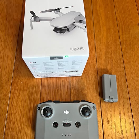 DJI Mini 2SE controller with phone holder, front view on desk.