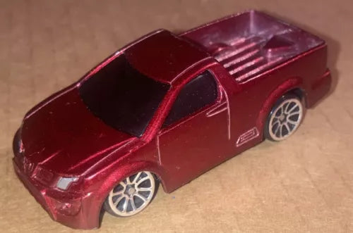 Burgundy 1:64 diecast pickup truck with silver rims, side view