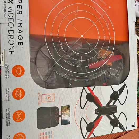 Quadcopter drone with red prop guards and black body shown on retail box