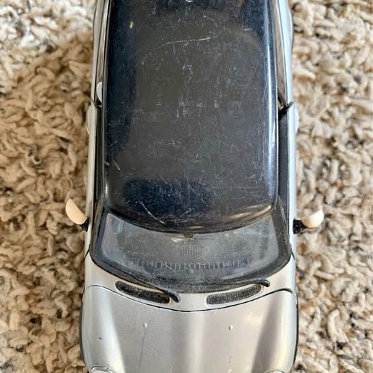 Mini Cooper 1:24 diecast model car, gray with black hood and front grille details