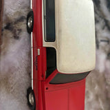 Die-cast SUV model in red and white, side view with door and front wheel