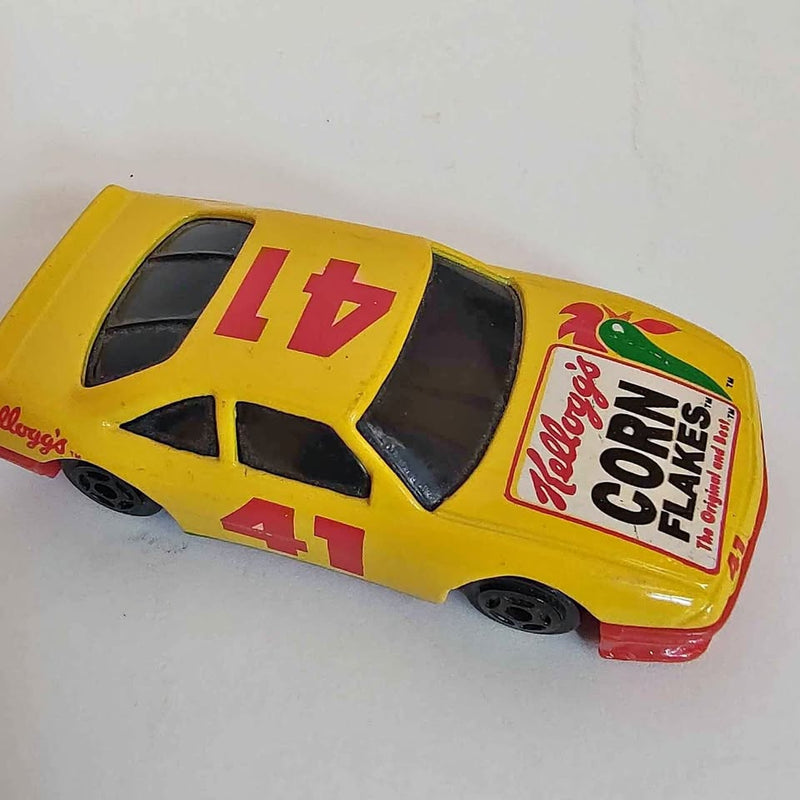 Yellow diecast metal toy car with #16 and 41 decals, Kellogg’s Corn Flakes branding