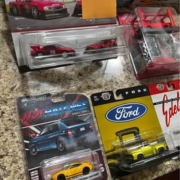Diecast car toy set in blister packaging with multiple vehicles, red and yellow