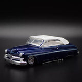 Blue convertible diecast model car with white top, front 3/4 view.