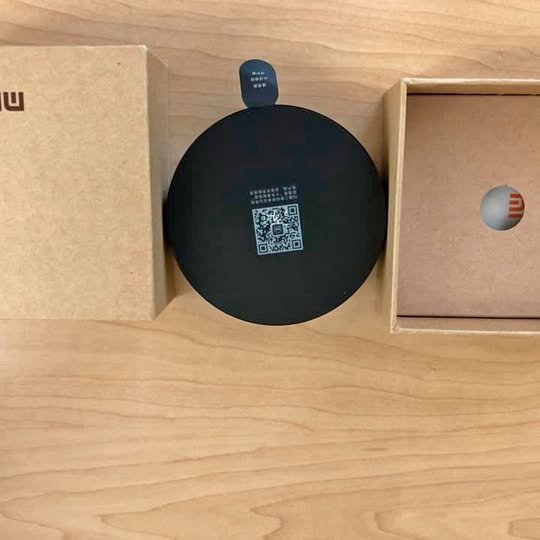 Xiaomi IR remote control puck, black circular device with QR code