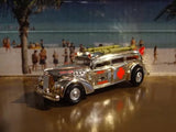 Die-cast ambulance model car, silver with red striping and black wheels