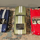 RoadLegends diecast car set with three striped cars: navy, olive, and red