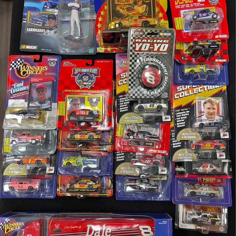 Assorted diecast collectible race cars in blister packaging