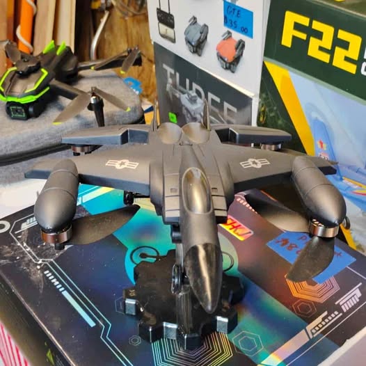 Quadcopter drone with four propellers and central controller body, dark gray