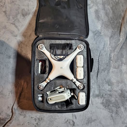 White drone in black hard-shell carry case with fitted foam compartments