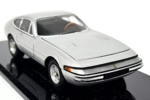 Silver diecast model car with opening parts, front three-quarter view, grille detail