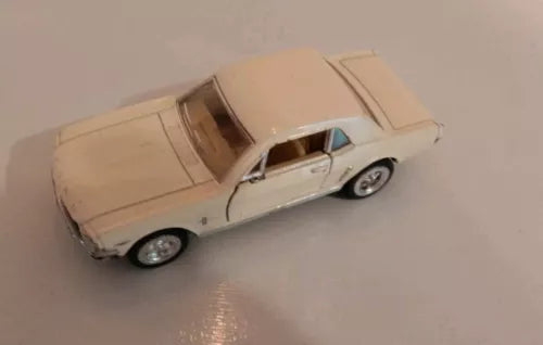 Light beige diecast model toy car with tan top, side view