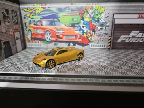 Gold Pagani Huayra diecast sports car model with black wheels