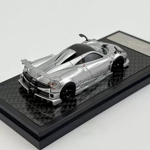 Silver 1:64 scale diecast sports car model with hood open on display base