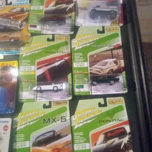 Diecast model car lot in blister packs, Johnny Lightning and Pontiac designs.