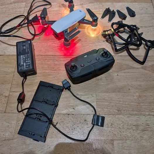DJI Spark drone with controller, batteries, and charging cables