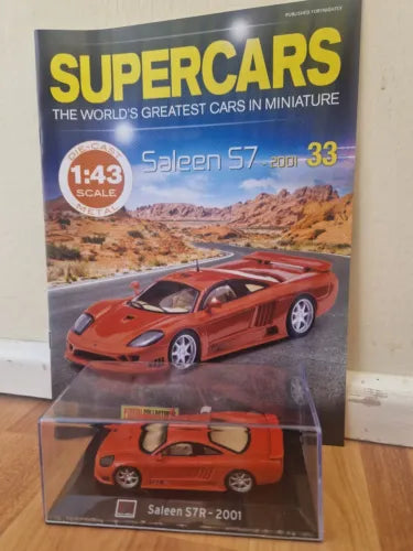 Diecast model car in retail box, orange sports car with #33 on packaging