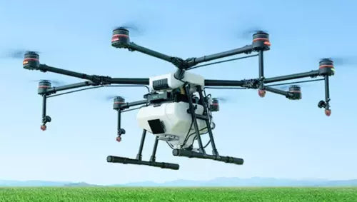 Agricultural spraying drone with quadcopter arms and spray boom