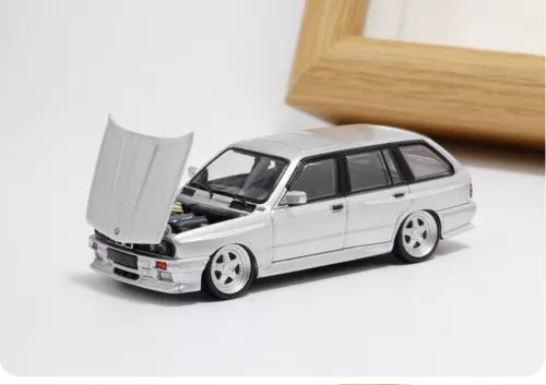 Silver diecast station wagon model car, 1/64 scale, with open hood