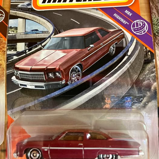 1/64 diecast car of a maroon classic coupe in a display blister
