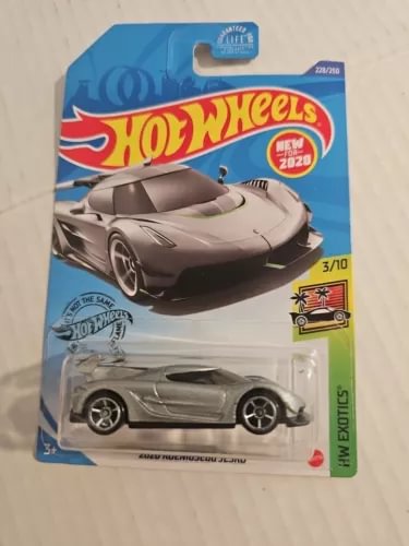 Gray die-cast sports car on blister card, side profile