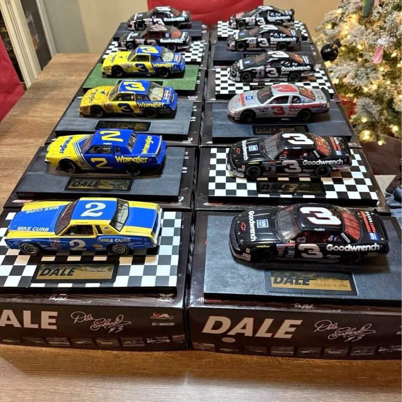 Set of 12 diecast stock cars in display boxes with checkered race track bases