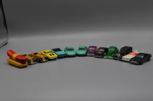 Diecast car lot of 13, assorted colorful cars lined up side by side