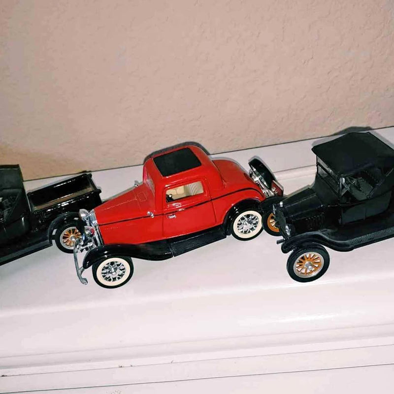 Red vintage diecast pickup model car with black roof and chrome wheels