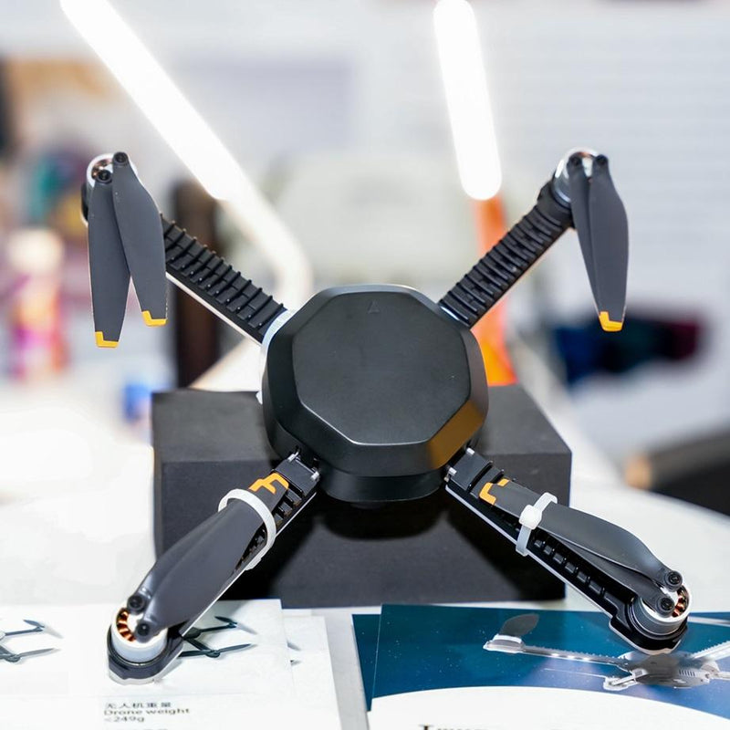 Quadcopter drone with four black propeller arms and central circular body