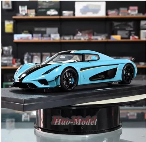 Resin diecast model car, light blue sports coupe with black side stripes on display base