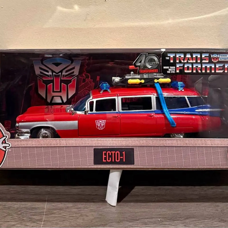 Red diecast Ecto-1 model car with blue equipment, in display packaging, front view