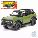 Green Ford Bronco diecast model car with black soft top, front 3/4 view