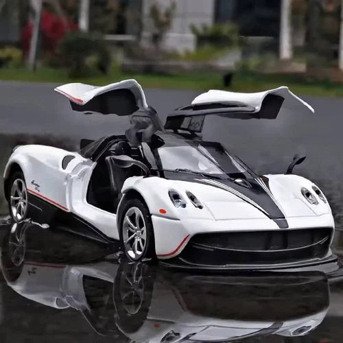 White diecast sports car model with black racing stripes and front aero details