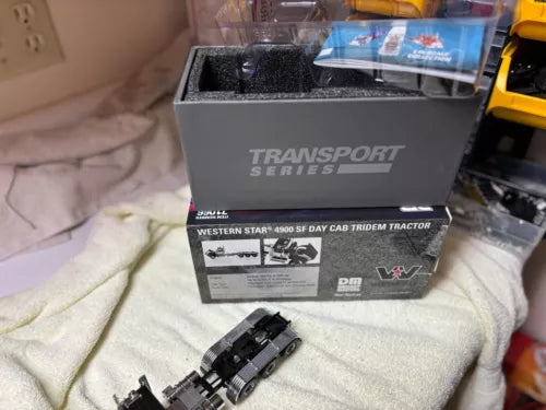 Black tridem day cab diecast truck model with transport series display box