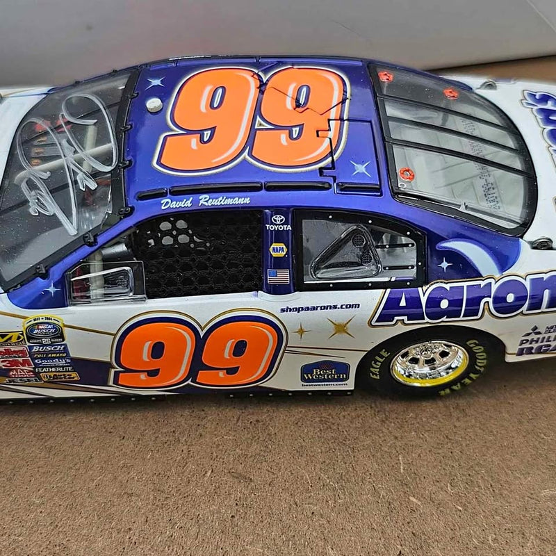 Diecast race car model in blue and white with large orange 99 numbers